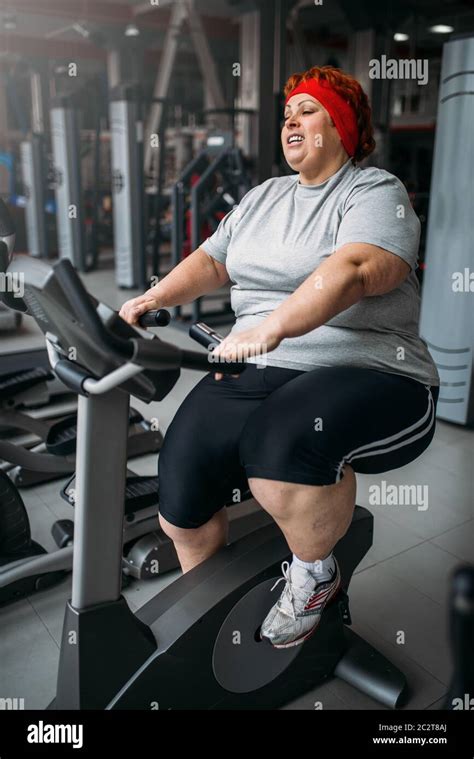 Fat Woman Training On Exercise Bike In Gym Calories Burning Obese