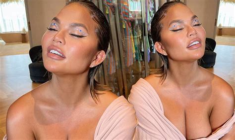 Chrissy Teigen Puts On A Busty Display In A Very Low Cut Pink Top