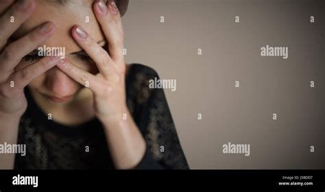Digital Composite Of Woman Hands Over Face Against Brown Background