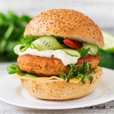 Give your burgers a healthy makeover with this spicy chicken burger recipe topped with crunchy carrot slaw. Cheesy Chicken Burger Recipe: How to Make Cheesy Chicken Burger