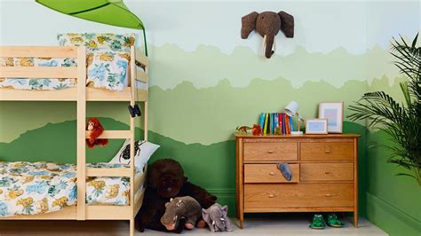 Colorful parrots and bright animals peeping through jungle vines can stimulate a new baby's curiosity. How to Create a Jungle Themed Kids Bedroom | Dulux