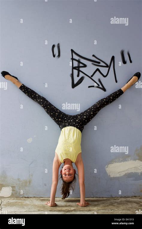 Teenage Girl Doing Handstand Against Wall Stock Photo Alamy