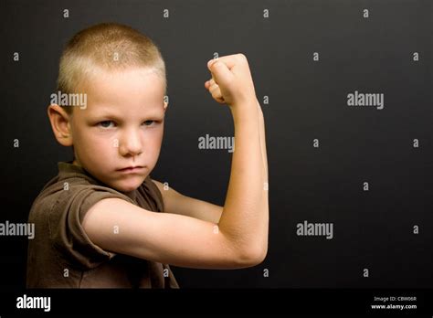 Young Boy Flexing His Muscles And Looking Tough Stock Photo Alamy