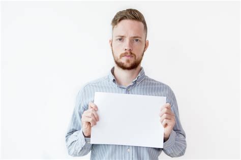 Free Photo Serious Man Holding Blank Sheet Of Paper