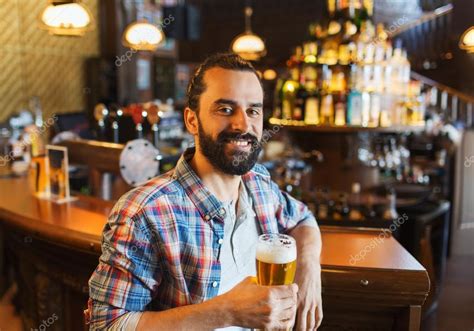 Happy Man Drinking Beer At Bar Or Pub Stock Photo By ©sydaproductions