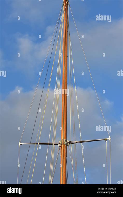 Wooden Mast Of Classic Yacht With Shrouds Supported By Spreaders And