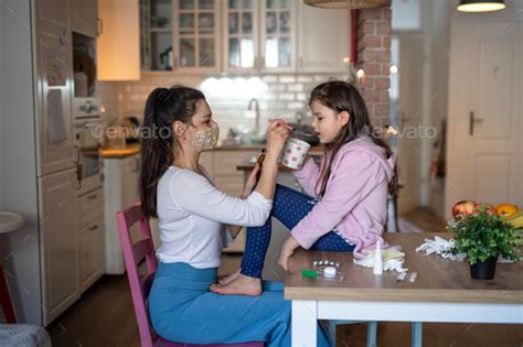 Mother Looking After Sick Small Daughter At Home Stock Photo By Halfpoint