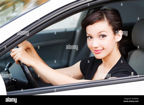 Pretty Woman Driver Smiling To You From The White Car Stock Photo Alamy