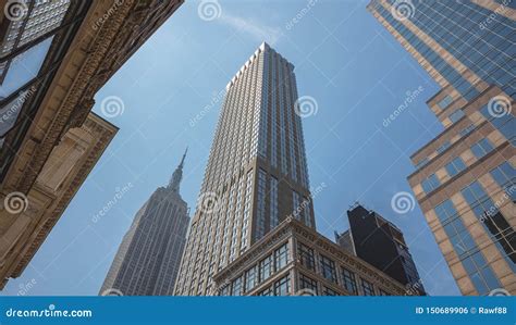 New York Manhattan High Buildings View From Below Against Blue Sky