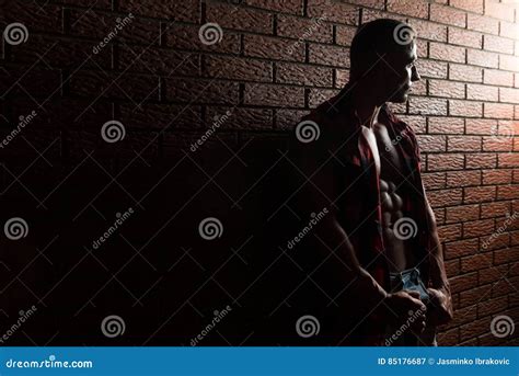 Man Standing Strong On Wall Of Bricks Stock Image Image Of