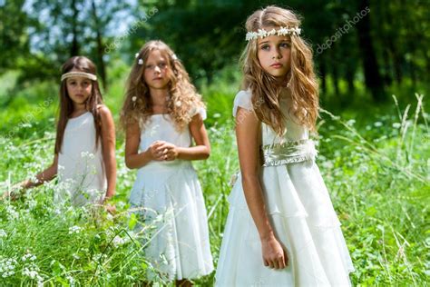 Three Girls Wearing White Dresses In Woods Stock Photo By ©karelnoppe