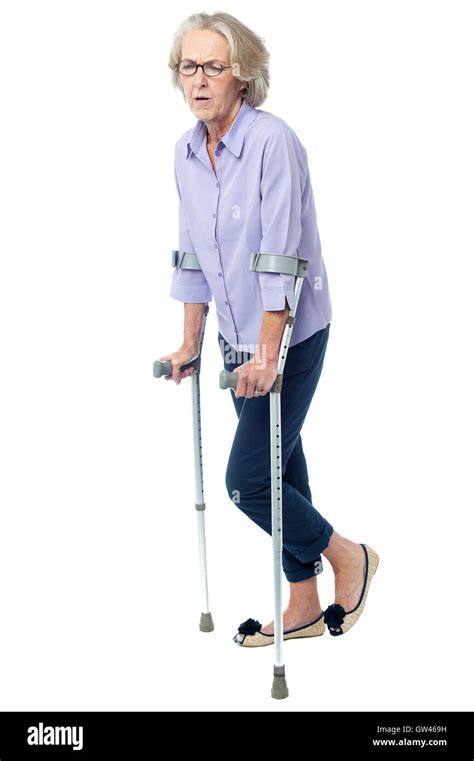 Aged Woman In Pain Walking With Crutches Stock Photo Alamy