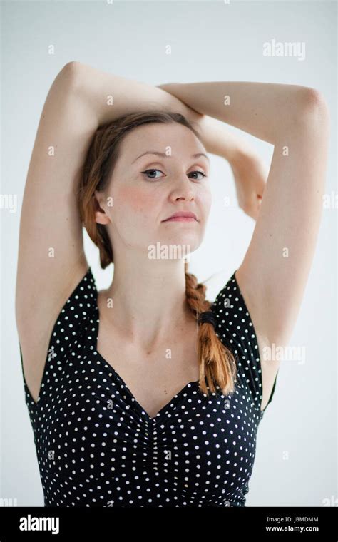 Studio Portrait Of Relaxed Looking Attractive Woman With Pigtail