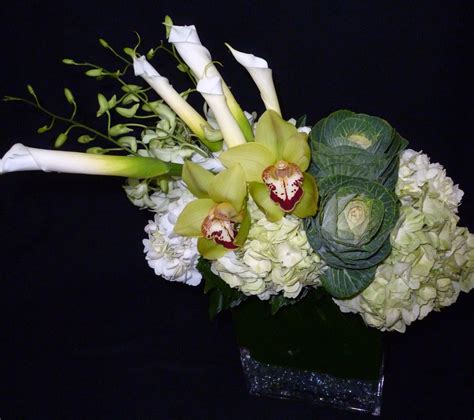 This Is An Arrangement Featuring White Calla Lilies Green Cymbidium Orchids Kale And White