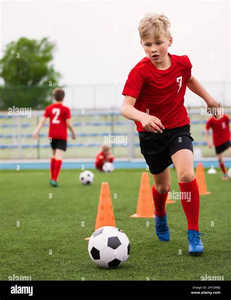 Soccer Boy On Training With Ball And Soccer Cones Dribbling Drill