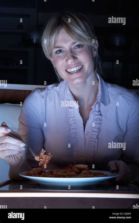 Woman Enjoying Meal Whilst Watching Tv Stock Photo Alamy