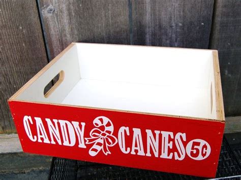 A Red And White Candy Cane Box Sitting On Top Of A Wire Rack In Front