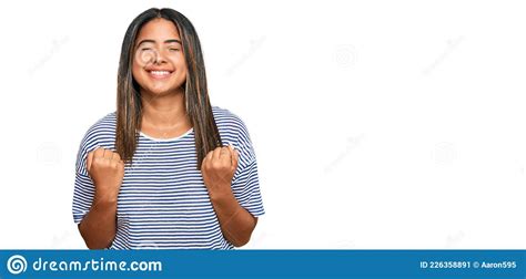 Young Latin Girl Wearing Casual Clothes Very Happy And Excited Doing Winner Gesture With Arms