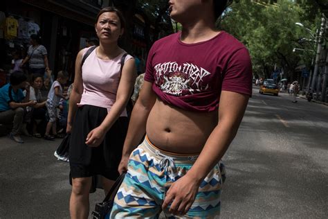 How Some Chinese Men Meet Summer’s Swelter With Midriff Bare And