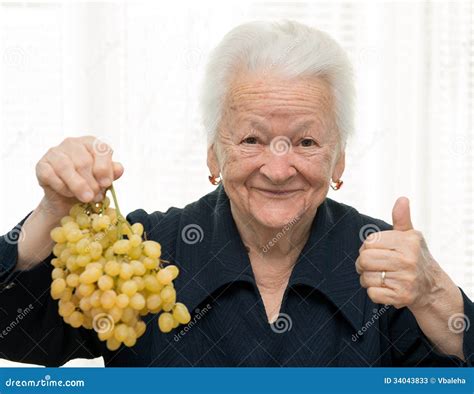 Senior Woman Holding A Bunch Of Grape Stock Photos Image 34043833