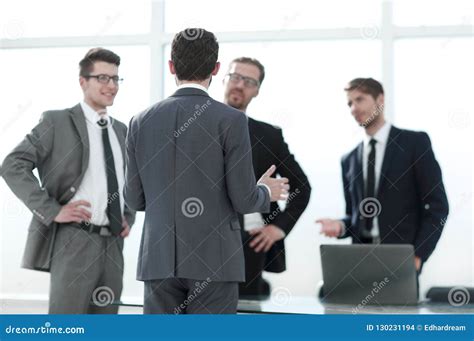 Boss Talking To Employees Standing In The Office Stock Photo Image Of