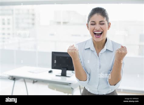Happy Businesswoman Clenching Fists In Office Stock Photo Alamy