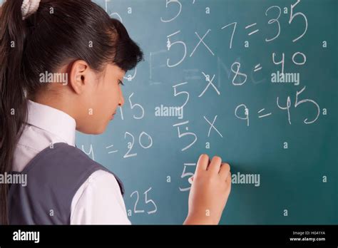 Girl Writing On Blackboard In A Classroom Stock Photo Alamy