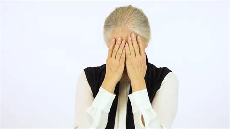 An Elderly Woman Cries With Hands Over Her Face White Screen Studio
