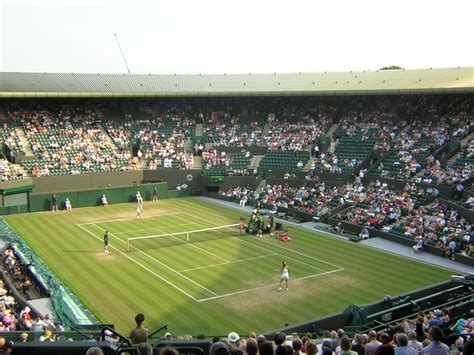 The sight of courts covered in luscious, green grass and fans watching as they savor strawberries and cream can only mean one thing: File:Wimbledon Court 1.jpg - Wikimedia Commons
