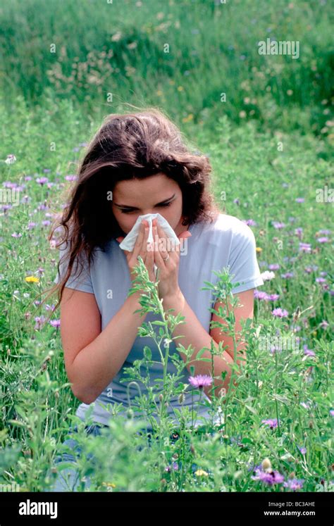 Young Woman Being Woman Allergic In Flower Field Running Nose Blow Nose In Hankie Outside