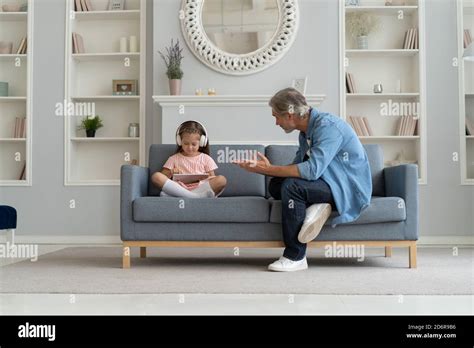 Serious Father Scolding Little Daughter In Home Interior Stock Photo