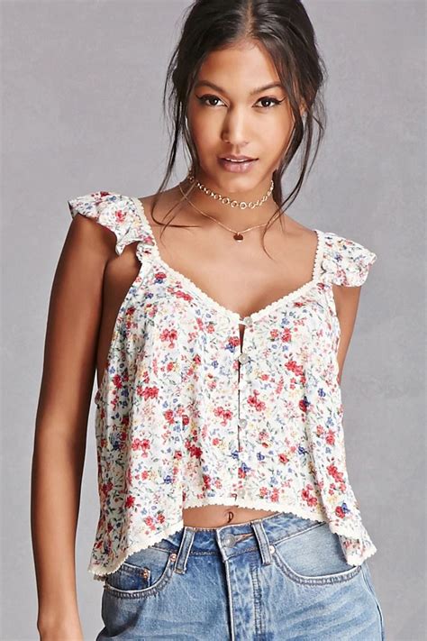 a woven crop top featuring an allover floral print button down front ruffled straps and a
