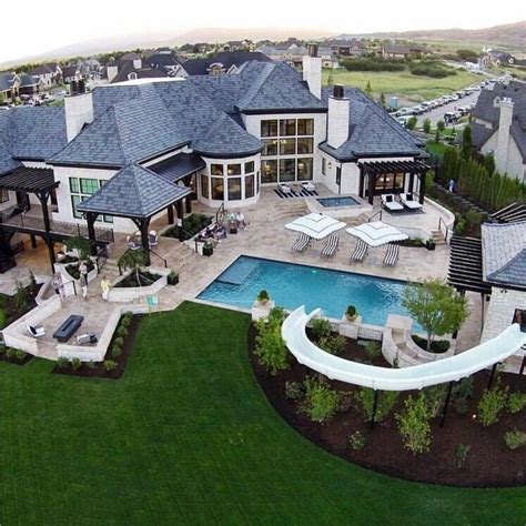 An Aerial View Of A Large Home With A Pool And Hot Tub In The Yard