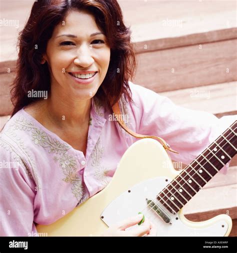 Portrait Of A Mature Woman Playing The Guitar Stock Photo Alamy