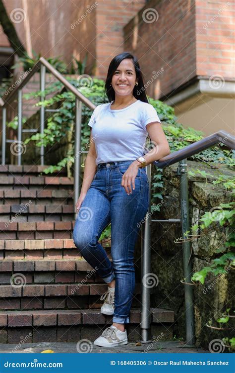 Beautiful Colombian Woman Lying On The Railing Of Some City Stairs