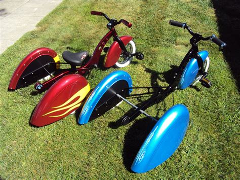 Three Colorful Tricycles Sitting In The Grass