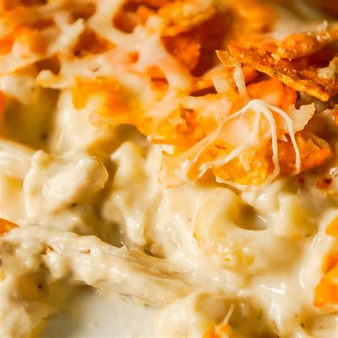 In a medium bowl, stir together the chicken, soup, sour cream, half of the cheddar, ro*tel, cumin, and chili powder. Doritos Mac and Cheese Casserole with Chicken - This is ...