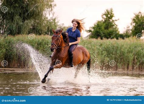 A Young Girl Riding A Horse On A Shallow Lake A Horse Runs On Water At