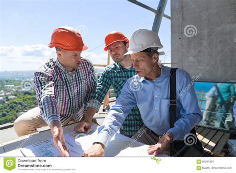 Team of Builders Working with Blueprint on Site Architect Explain