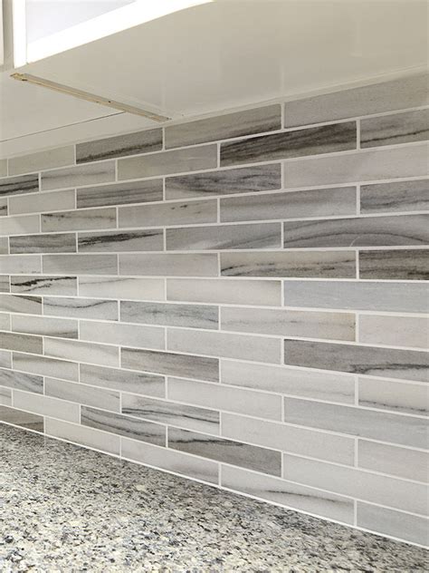 The range for porcelain tile, for both material and installation, can range from $8 to $15 dollars per square foot. Modern White Gray Subway Marble Backsplash Tile