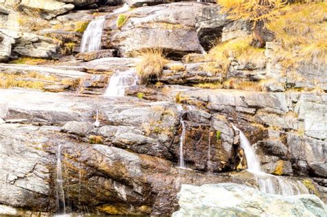 Water Cascading Over Rocks Waterfall And Autumn Colors In The