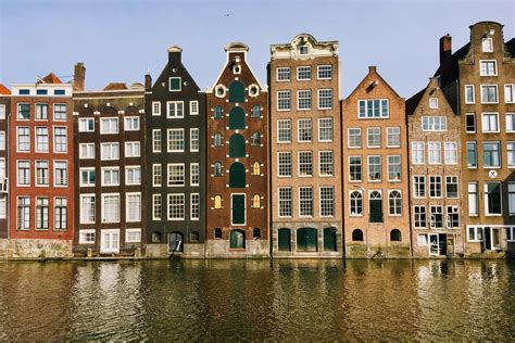 the dancing houses along the damrak canal in amsterdam r travel