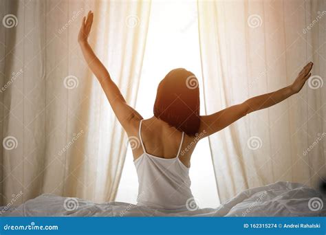 Woman Stretching Hands In Bed After Wake Up Sun Flare Brunette