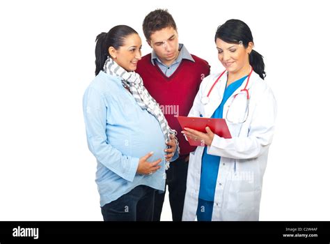 Worried Husband With Happy Pregnant Wife Having Conversation With Doctor And Giving To Pregnant