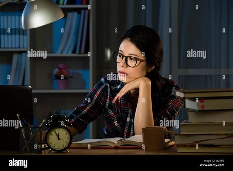 Young Bored Female College Student Studying Poorly At Late Evening