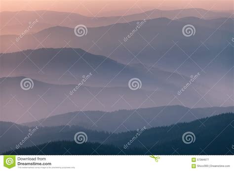 Distant Mountain Range And Thin Layer Of Clouds On The Valleys Stock
