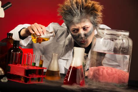 Mad Scientist At A Laboratory Table Filled With Test Tubes Stock Photo