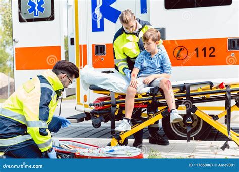 Emergency Doctors Caring For Accident Victim Boy Stock Image Image Of