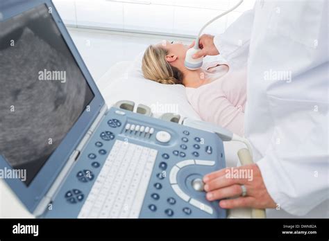 Doctor Performing Ultrasound Scan On Neck Of Patient Stock Photo Alamy