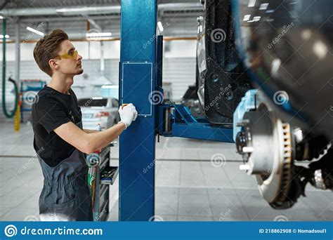 Male Mechanic Lifts The Car Auto Service Stock Photo Image Of Wrench